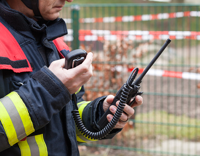 Firefighter in action with walkie takie in the hand